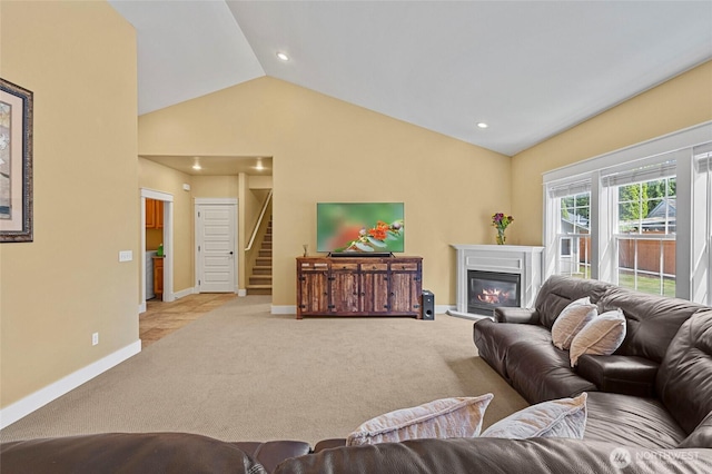 218 Lilly Ln, Mount Vernon, WA 98274 - carpeted living room with vaulted ceiling, a glass covered fireplace, stairs, and recessed lighting