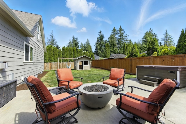 218 Lilly Ln, Mount Vernon, WA 98274 - fenced backyard with a hot tub, a patio, a shed, and an outdoor fire pit