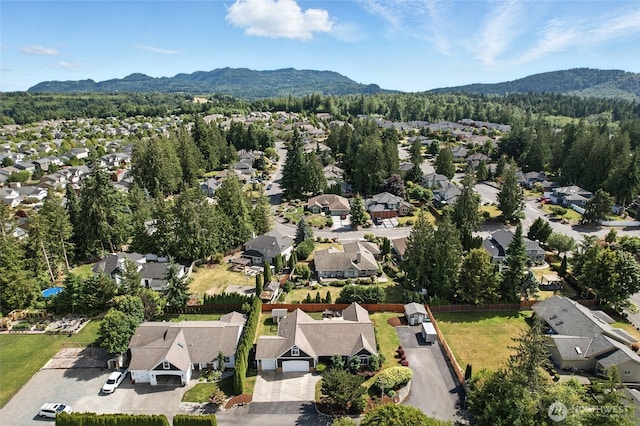 218 Lilly Ln, Mount Vernon, WA 98274 - aerial view of residential area featuring a mountainous background and a heavily wooded area