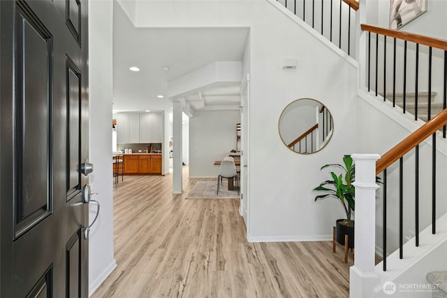 3419 NE Meadow Way, Issaquah, WA 98029 - foyer entrance featuring light wood-style flooring, stairway, recessed lighting, and ornate columns