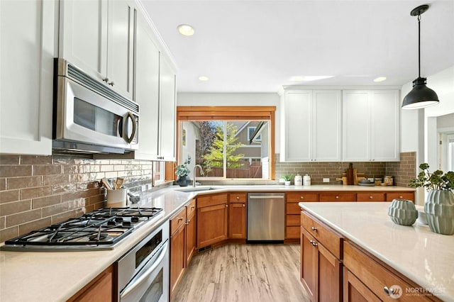 3419 NE Meadow Way, Issaquah, WA 98029 - kitchen featuring appliances with stainless steel finishes, light countertops, light wood-type flooring, tasteful backsplash, and recessed lighting