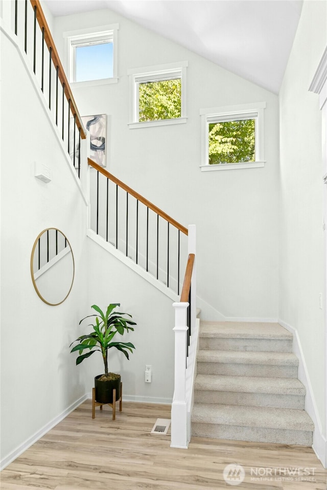 3419 NE Meadow Way, Issaquah, WA 98029 - staircase with wood finished floors, vaulted ceiling, and healthy amount of natural light