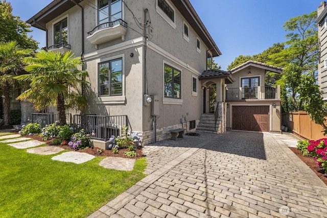 4043 55th Ave SW, Seattle, WA 98116 - view of property exterior featuring a garage, stucco siding, and decorative driveway