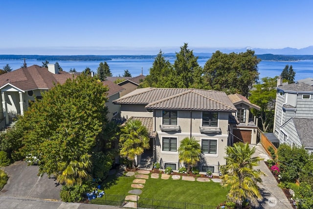 4043 55th Ave SW, Seattle, WA 98116 - view of front facade featuring stucco siding, a water view, and a tile roof