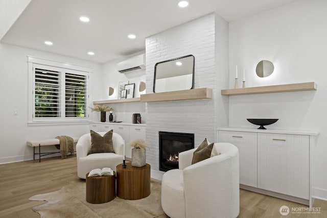 4043 55th Ave SW, Seattle, WA 98116 - living area featuring a wall mounted air conditioner, light wood finished floors, a brick fireplace, and recessed lighting
