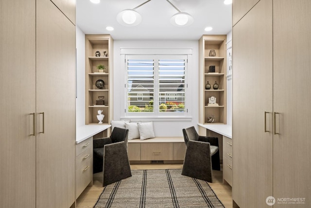 4043 55th Ave SW, Seattle, WA 98116 - office area featuring built in desk, light wood-style flooring, and built in features