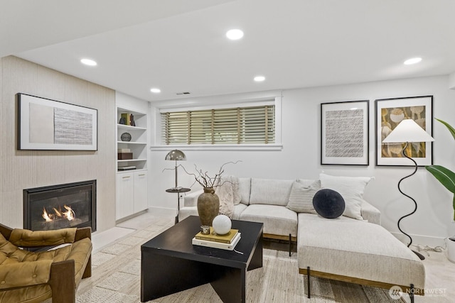 4043 55th Ave SW, Seattle, WA 98116 - living room with recessed lighting, built in shelves, and a glass covered fireplace