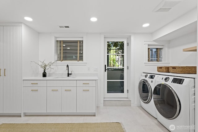 4043 55th Ave SW, Seattle, WA 98116 - washroom with independent washer and dryer, light tile patterned floors, recessed lighting, and cabinet space