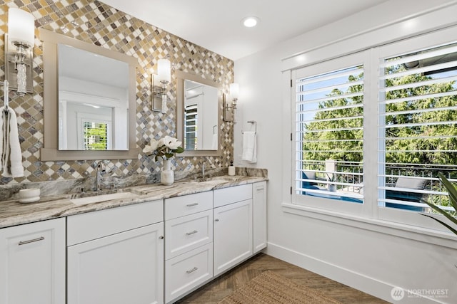 4043 55th Ave SW, Seattle, WA 98116 - bathroom featuring double vanity, healthy amount of natural light, decorative backsplash, and recessed lighting