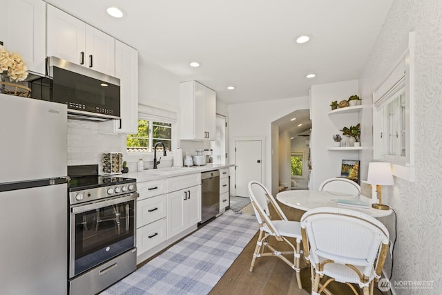 4043 55th Ave SW, Seattle, WA 98116 - kitchen featuring stainless steel appliances, white cabinetry, recessed lighting, light wood-style floors, and open shelves