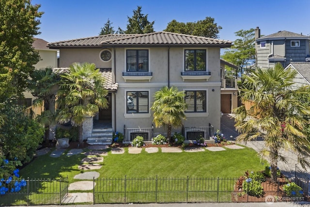 4043 55th Ave SW, Seattle, WA 98116 - back of house with a fenced front yard, stucco siding, and a balcony