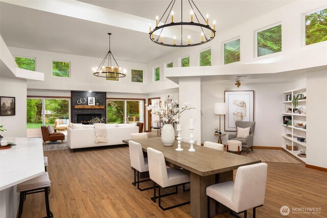 12407 Upper Preston Rd SE, Issaquah, WA 98027 - dining room featuring a chandelier, a high ceiling, wood finished floors, and healthy amount of natural light