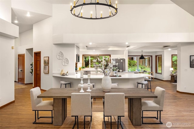 12407 Upper Preston Rd SE, Issaquah, WA 98027 - dining room featuring wood finished floors, a chandelier, recessed lighting, and a high ceiling