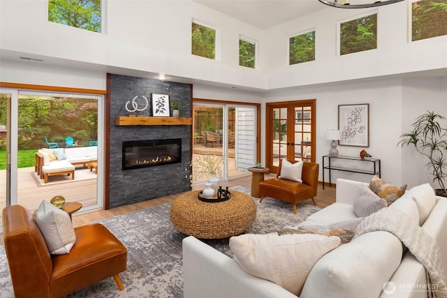 12407 Upper Preston Rd SE, Issaquah, WA 98027 - living room featuring a towering ceiling, plenty of natural light, wood finished floors, and a fireplace