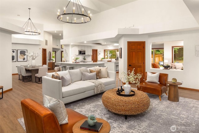 12407 Upper Preston Rd SE, Issaquah, WA 98027 - living room featuring a chandelier, light wood-style floors, and a towering ceiling
