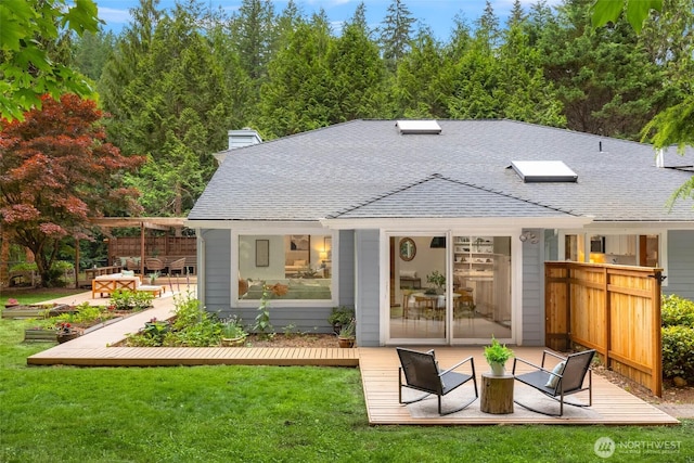 12407 Upper Preston Rd SE, Issaquah, WA 98027 - rear view of property featuring a deck, a lawn, roof with shingles, and a chimney