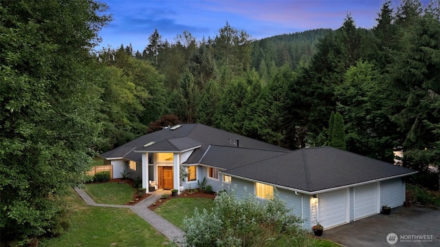 12407 Upper Preston Rd SE, Issaquah, WA 98027 - single story home with a view of trees, an attached garage, a lawn, and driveway