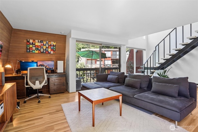 10765 Burke Ave N Unit 14, Seattle, WA 98133 - living room featuring wood walls, light wood-type flooring, stairs, and built in desk