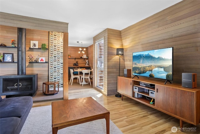 10765 Burke Ave N Unit 14, Seattle, WA 98133 - living room with wooden walls, a wood stove, and wood finished floors
