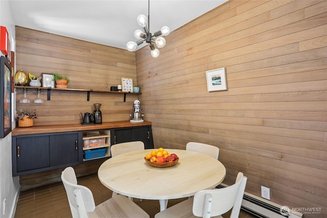 10765 Burke Ave N Unit 14, Seattle, WA 98133 - dining space featuring a chandelier, wood walls, and a baseboard heating unit