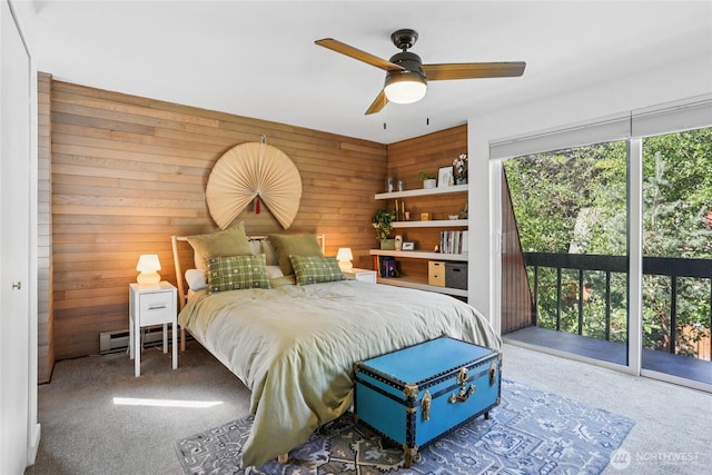 10765 Burke Ave N Unit 14, Seattle, WA 98133 - bedroom with access to exterior, carpet, wood walls, baseboard heating, and ceiling fan