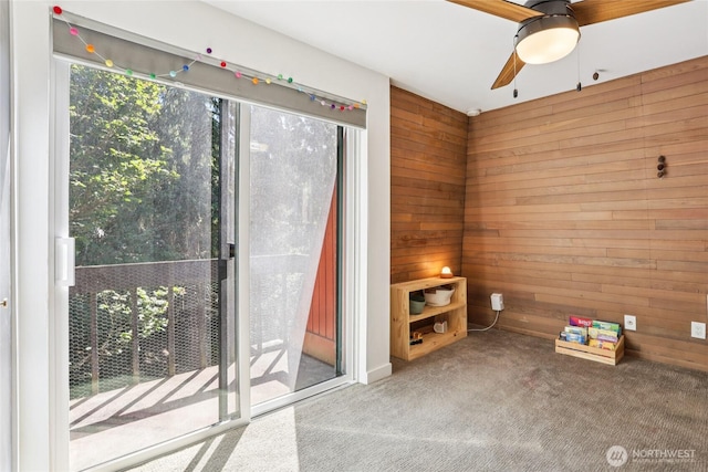 10765 Burke Ave N Unit 14, Seattle, WA 98133 - spare room with wooden walls, ceiling fan, and carpet flooring
