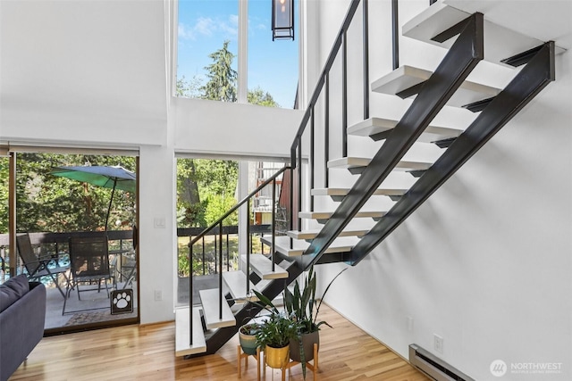 10765 Burke Ave N Unit 14, Seattle, WA 98133 - stairs with a high ceiling and wood finished floors