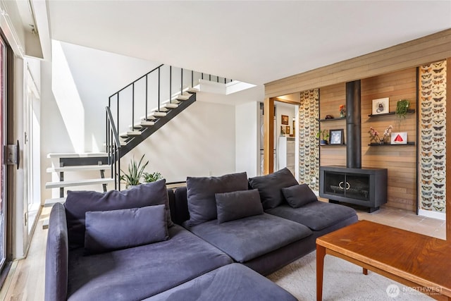 10765 Burke Ave N Unit 14, Seattle, WA 98133 - living area with a wood stove, stairway, and wood walls