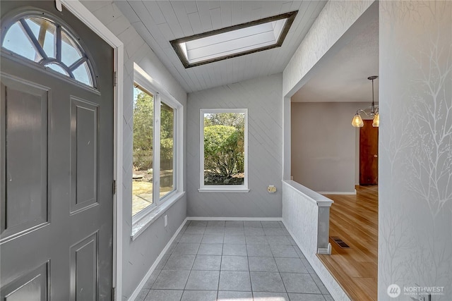 622 119th Ave E, Edgewood, WA 98372 - entryway featuring vaulted ceiling, a skylight, and light tile patterned flooring