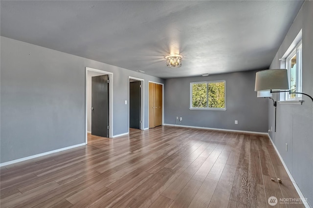 622 119th Ave E, Edgewood, WA 98372 - spare room featuring wood finished floors and baseboards