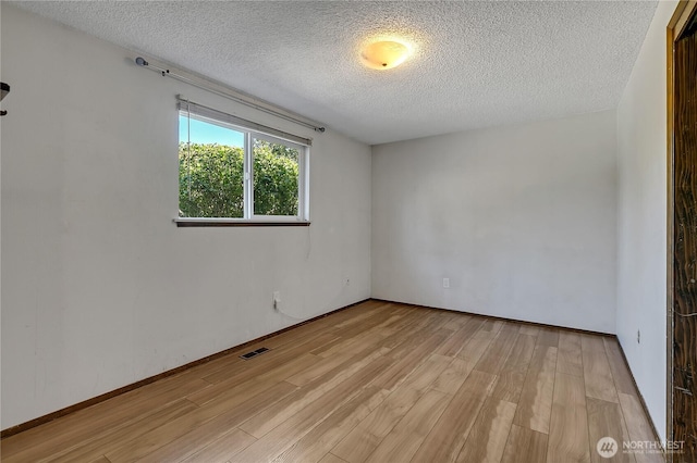 622 119th Ave E, Edgewood, WA 98372 - unfurnished room featuring light wood finished floors and a textured ceiling