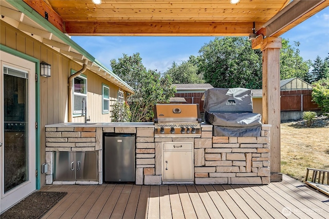 622 119th Ave E, Edgewood, WA 98372 - wooden deck with an outdoor kitchen and a sink