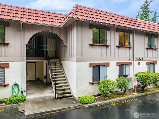 15749 NE 18th St Unit B5, Bellevue, WA 98008 - view of property featuring stairs, a water view, and parking
