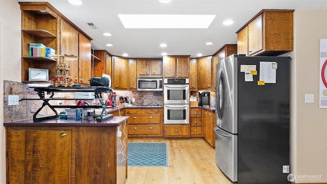 87 Sullivan Pl, Walla Walla, WA 99362 - kitchen featuring appliances with stainless steel finishes, brown cabinets, open shelves, light wood finished floors, and tasteful backsplash
