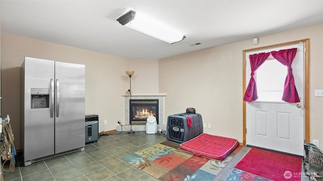 87 Sullivan Pl, Walla Walla, WA 99362 - interior space with stainless steel fridge, a fireplace, and dark tile patterned flooring