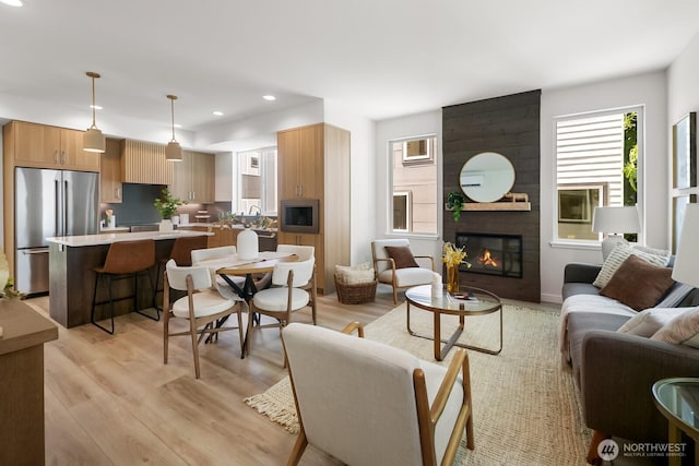1746A NW 62nd St, Seattle, WA 98107 - living area with light wood-type flooring, a fireplace, and recessed lighting