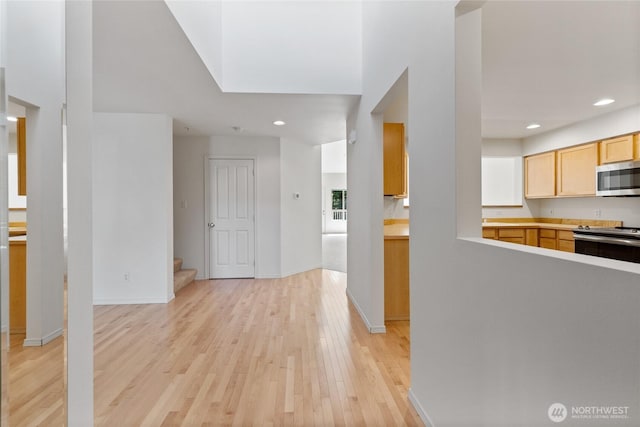 22532 43rd Ave S Unit 19-2, Kent, WA 98032 - kitchen featuring appliances with stainless steel finishes, light wood-type flooring, light brown cabinetry, recessed lighting, and light countertops