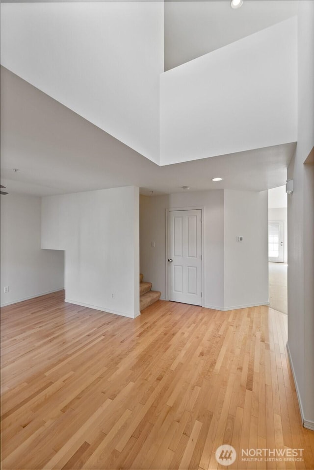 22532 43rd Ave S Unit 19-2, Kent, WA 98032 - empty room featuring stairs, light wood-type flooring, a high ceiling, and recessed lighting
