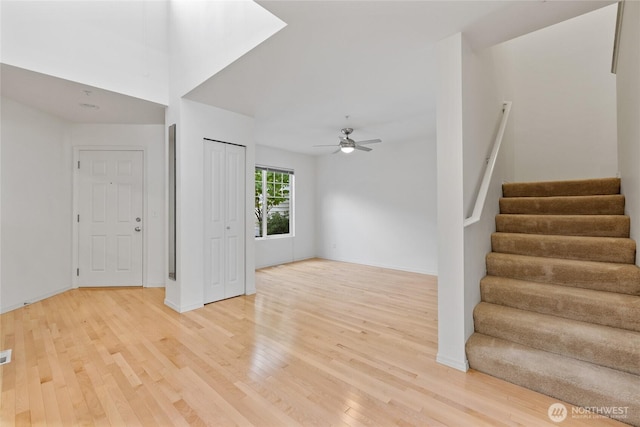 22532 43rd Ave S Unit 19-2, Kent, WA 98032 - unfurnished living room featuring light wood-style floors, stairway, and ceiling fan