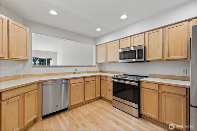 22532 43rd Ave S Unit 19-2, Kent, WA 98032 - kitchen with stainless steel appliances, light brown cabinets, light wood-style flooring, light countertops, and recessed lighting