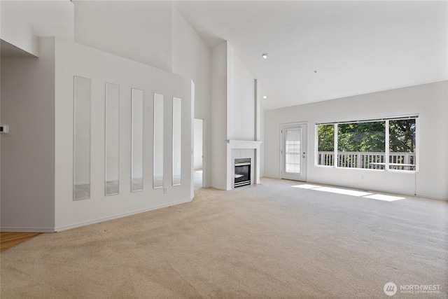 22532 43rd Ave S Unit 19-2, Kent, WA 98032 - unfurnished living room with high vaulted ceiling, light colored carpet, and a tiled fireplace
