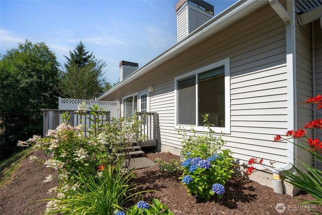 22532 43rd Ave S Unit 19-2, Kent, WA 98032 - view of property exterior featuring a chimney and a wooden deck