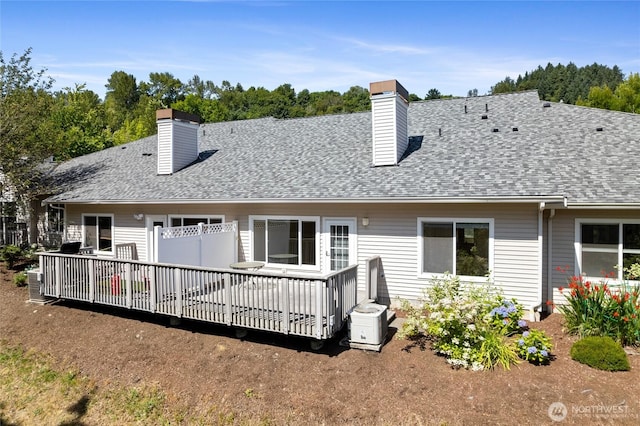 22532 43rd Ave S Unit 19-2, Kent, WA 98032 - back of property featuring a chimney, a shingled roof, and a deck
