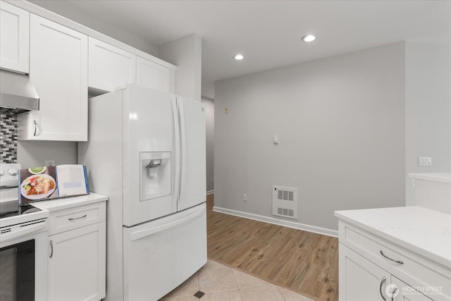 15000 Juanita Dr NE Unit 402, Kenmore, WA 98028 - kitchen with white appliances, light tile patterned floors, white cabinetry, light countertops, and recessed lighting