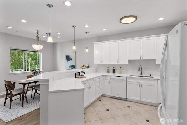 15000 Juanita Dr NE Unit 402, Kenmore, WA 98028 - kitchen with white appliances, a peninsula, white cabinetry, light countertops, and recessed lighting
