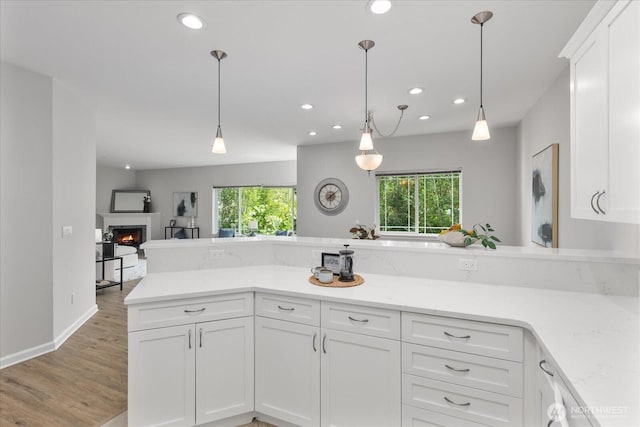 15000 Juanita Dr NE Unit 402, Kenmore, WA 98028 - kitchen with plenty of natural light, recessed lighting, light wood-type flooring, and white cabinets