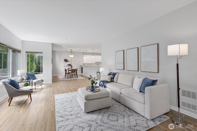 15000 Juanita Dr NE Unit 402, Kenmore, WA 98028 - living room with radiator heating unit, wood finished floors, and recessed lighting