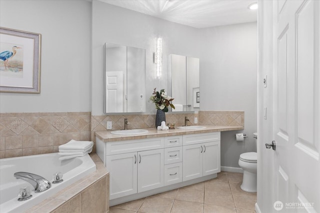 15000 Juanita Dr NE Unit 402, Kenmore, WA 98028 - bathroom featuring double vanity, a garden tub, and tile patterned floors