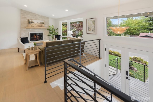 7502 117th Ave NE, Kirkland, WA 98033 - living room featuring light wood-style flooring, lofted ceiling, recessed lighting, a fireplace, and a chandelier
