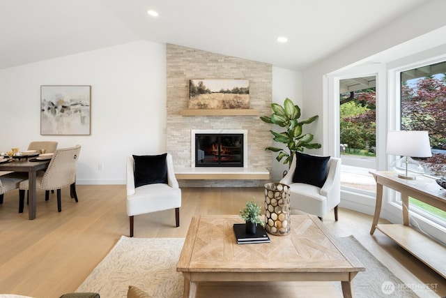 7502 117th Ave NE, Kirkland, WA 98033 - living room with vaulted ceiling, light wood-style floors, a fireplace, and recessed lighting